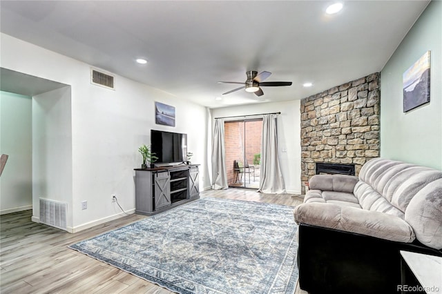 420 Wright St Unit 101, Lakewood, CO 80228 - living area with a ceiling fan, wood finished floors, recessed lighting, a stone fireplace, and baseboards