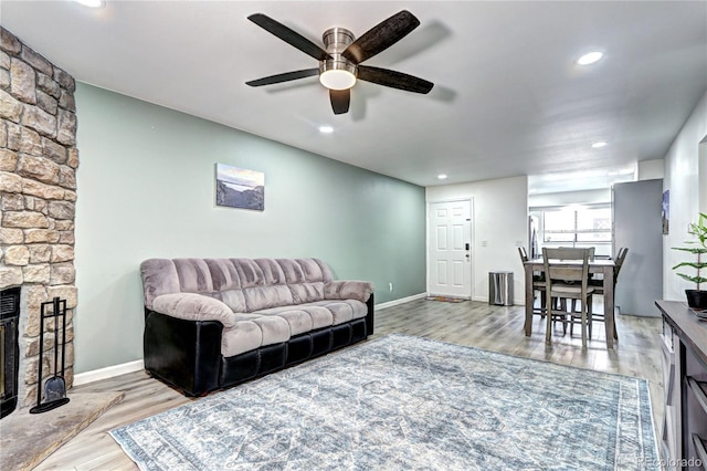 420 Wright St Unit 101, Lakewood, CO 80228 - living area featuring wood finished floors, a ceiling fan, baseboards, recessed lighting, and a fireplace
