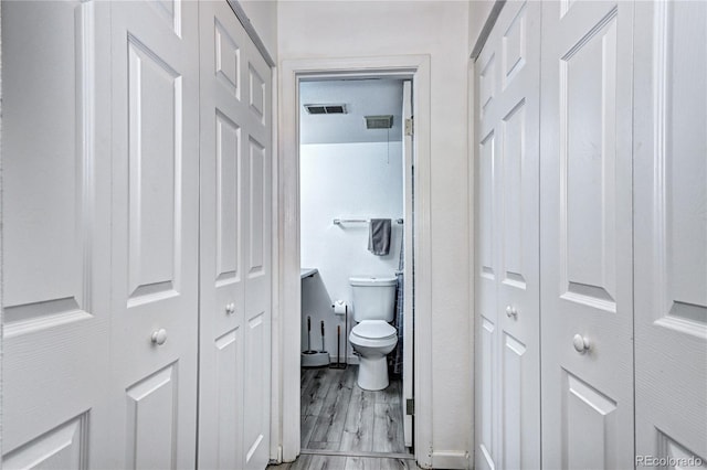 420 Wright St Unit 101, Lakewood, CO 80228 - bathroom with a closet, toilet, wood finished floors, and baseboards