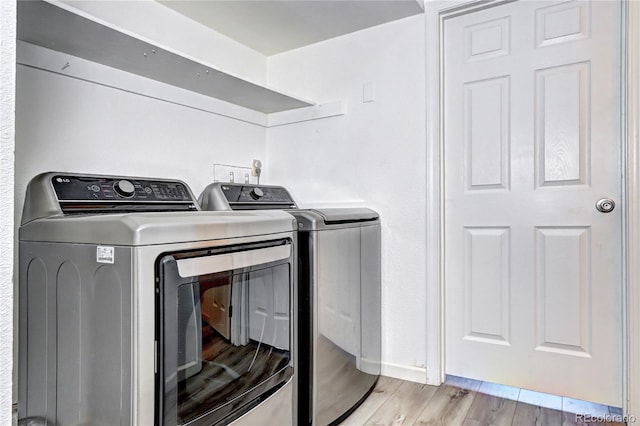 420 Wright St Unit 101, Lakewood, CO 80228 - laundry room featuring washing machine and clothes dryer and light wood-style floors
