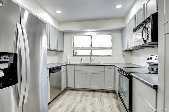 420 Wright St Unit 101, Lakewood, CO 80228 - kitchen featuring appliances with stainless steel finishes, light wood finished floors, and recessed lighting