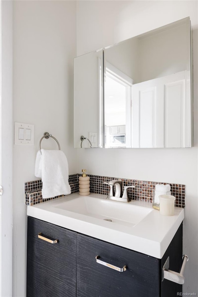 bathroom with vanity and decorative backsplash