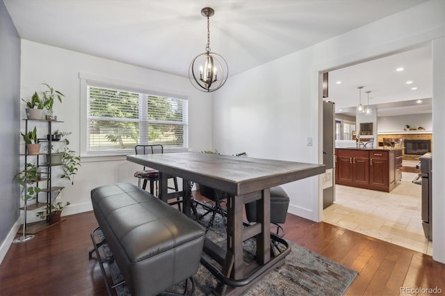 dining area with a notable chandelier and light wood-type flooring