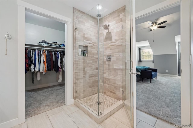 bathroom featuring tile patterned flooring, an enclosed shower, and ceiling fan