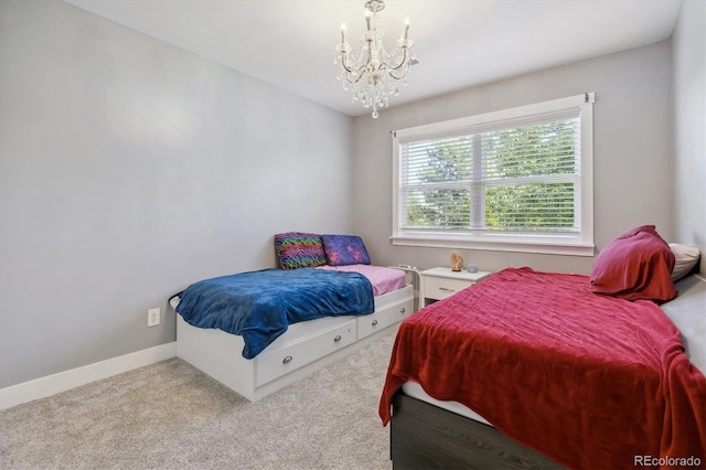 carpeted bedroom with a notable chandelier