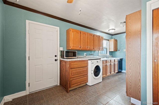 kitchen with washer / dryer, baseboards, stainless steel microwave, ornamental molding, and light countertops