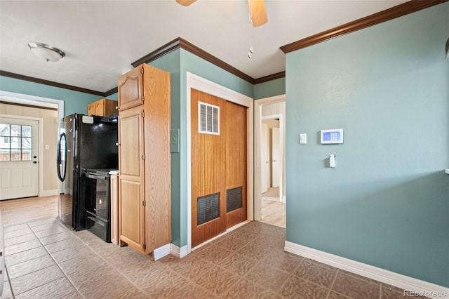 kitchen with black appliances, visible vents, baseboards, and crown molding