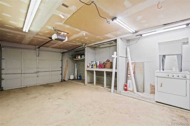 garage with a garage door opener and washer / clothes dryer