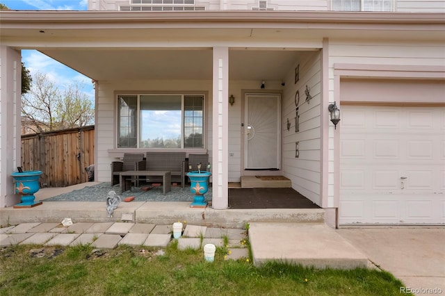 20292 E 47th Ave, Denver, CO 80249 - view of exterior entry with a porch, a garage, and fence