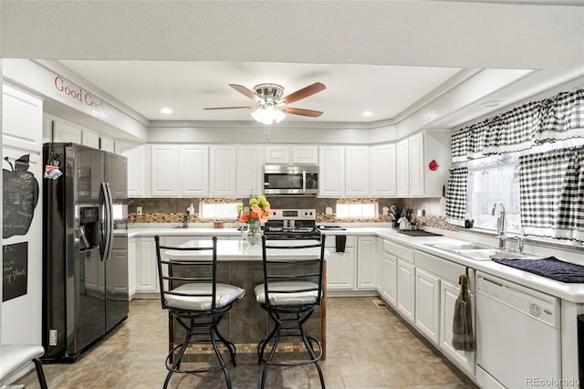 20292 E 47th Ave, Denver, CO 80249 - kitchen with a sink, light countertops, stainless steel appliances, and white cabinetry