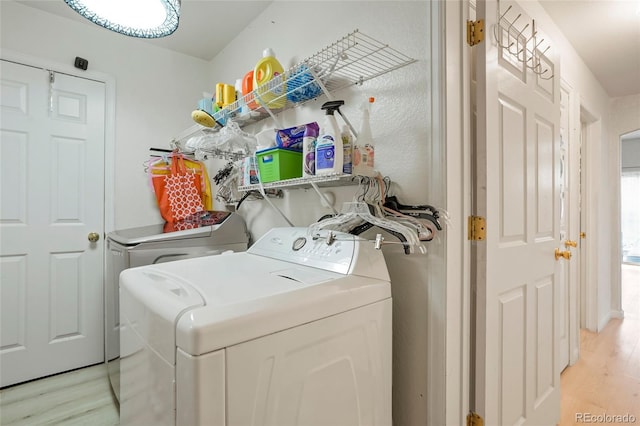 20292 E 47th Ave, Denver, CO 80249 - washroom with light wood-style floors, laundry area, and washer and clothes dryer