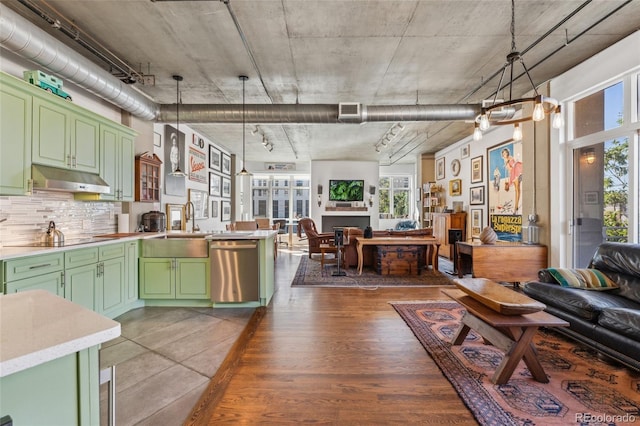 kitchen with sink, decorative light fixtures, dishwasher, and green cabinets