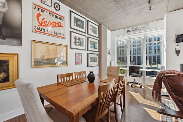 dining area with dark hardwood / wood-style flooring