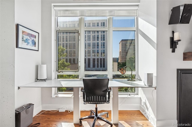 office area featuring wood-type flooring and built in desk