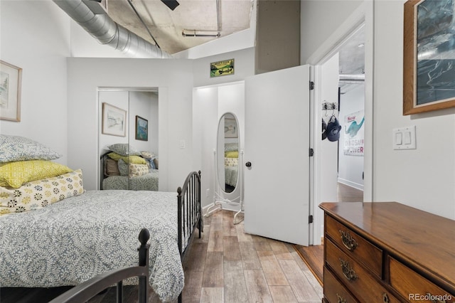 bedroom featuring hardwood / wood-style floors and a closet