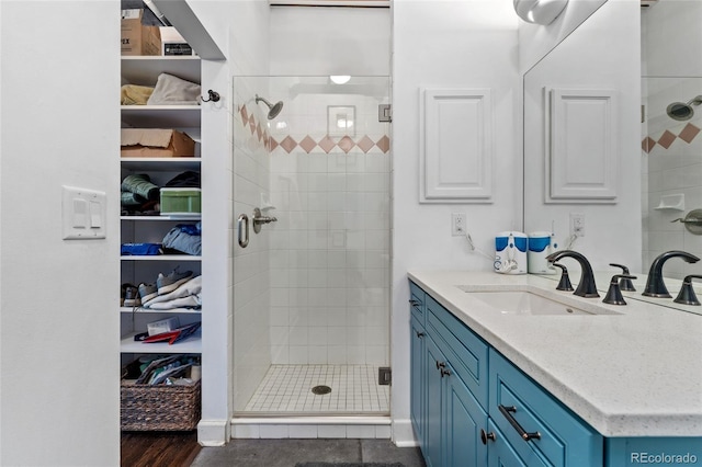 bathroom featuring an enclosed shower and vanity