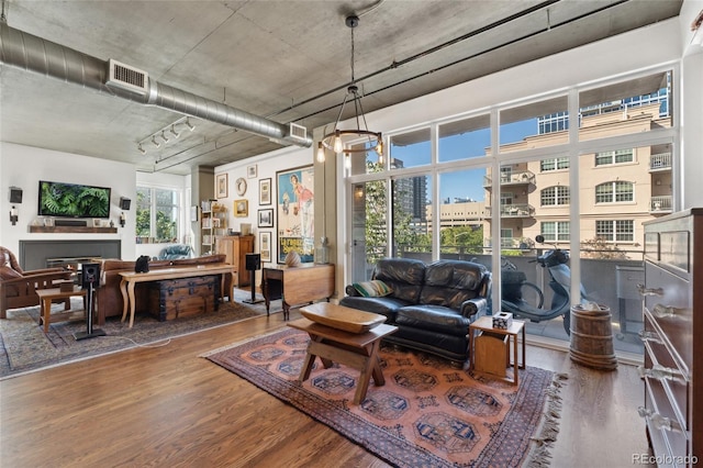 living area with visible vents and wood finished floors