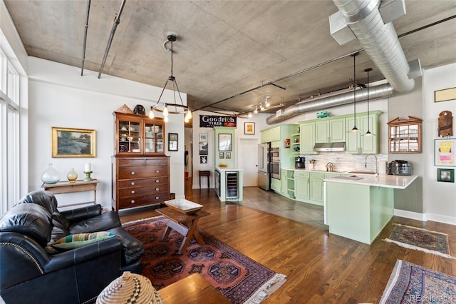 living area featuring baseboards, dark wood-style flooring, and wine cooler