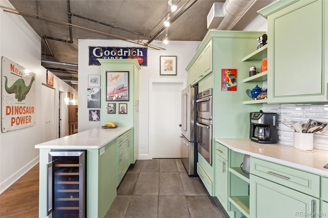 kitchen with beverage cooler, open shelves, and green cabinets
