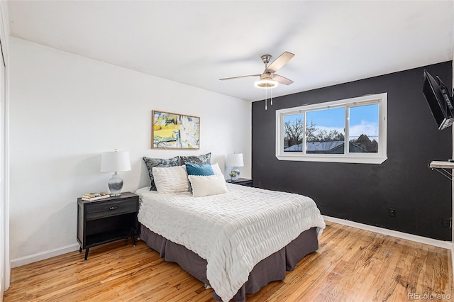 bedroom with ceiling fan and light hardwood / wood-style flooring