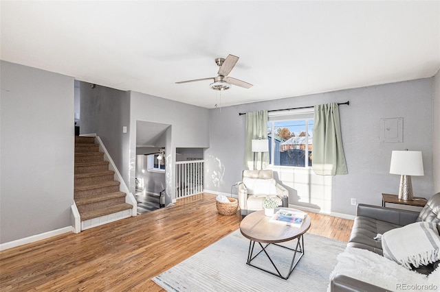 living room featuring hardwood / wood-style floors and ceiling fan