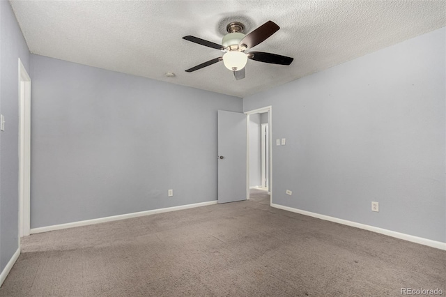 carpeted empty room with baseboards, a textured ceiling, and ceiling fan