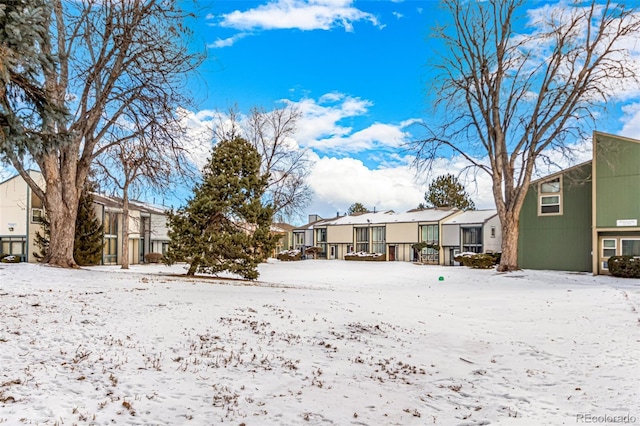 snow covered property with a residential view