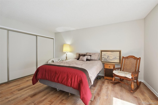 bedroom with a closet and wood finished floors