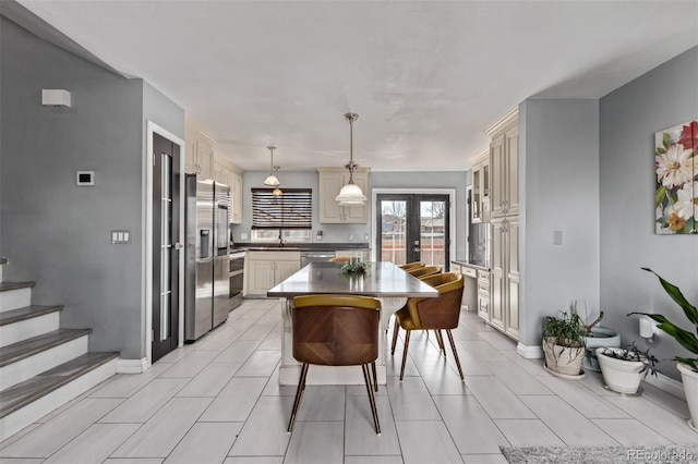 dining area with french doors, stairway, and baseboards