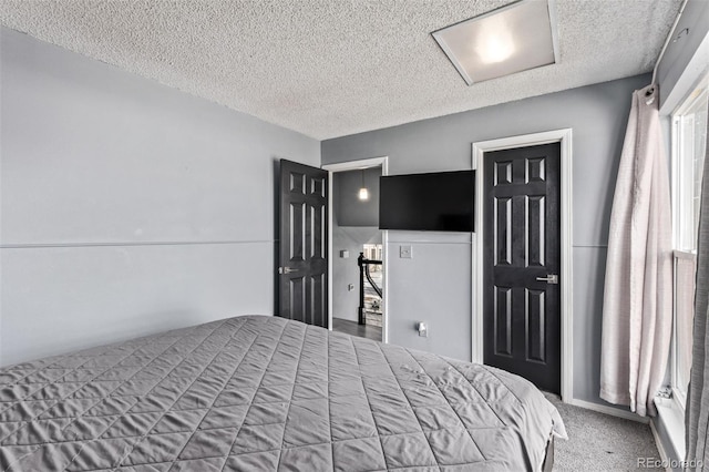 bedroom featuring carpet and a textured ceiling