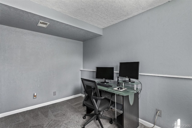 home office with visible vents, baseboards, a textured wall, carpet, and a textured ceiling