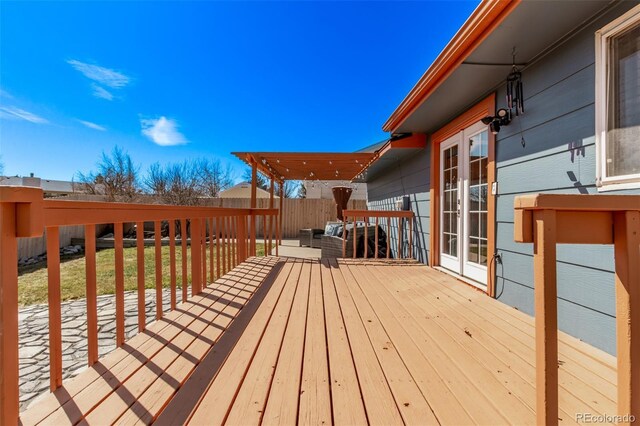 deck with a fenced backyard and french doors