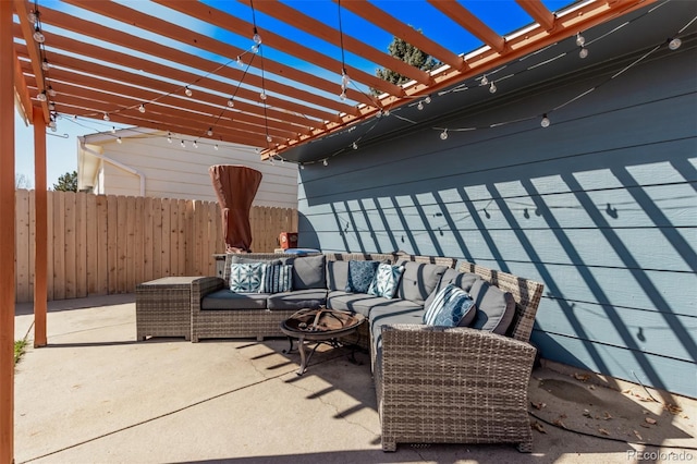 view of patio / terrace featuring fence, an outdoor living space, and a pergola