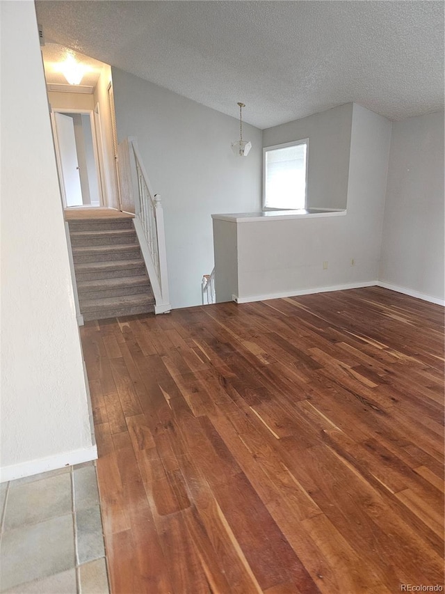 880 Orion Dr, Lafayette, CO 80026 - empty room featuring wood-type flooring, a textured ceiling, and baseboards