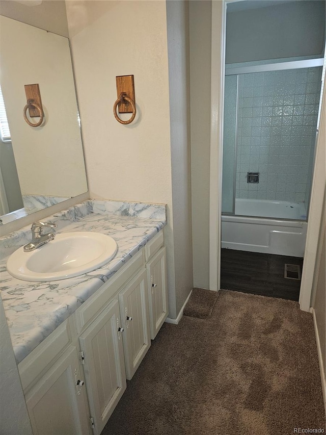880 Orion Dr, Lafayette, CO 80026 - bathroom with vanity, bath / shower combo with glass door, and baseboards