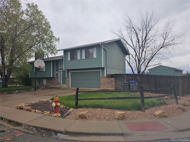 880 Orion Dr, Lafayette, CO 80026 - view of front of house featuring brick siding, driveway, an attached garage, and a chimney