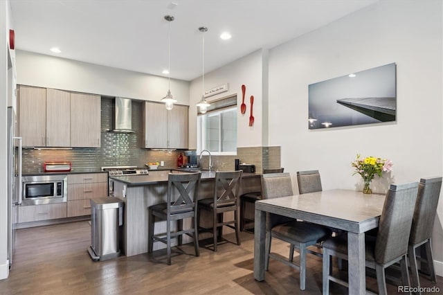 2898 W 22nd Ave, Denver, CO 80211 - kitchen featuring wall chimney range hood, modern cabinets, stainless steel appliances, dark countertops, and decorative backsplash