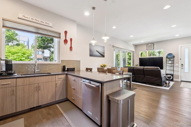 2898 W 22nd Ave, Denver, CO 80211 - kitchen with a sink, dishwasher, wood finished floors, a peninsula, and dark countertops