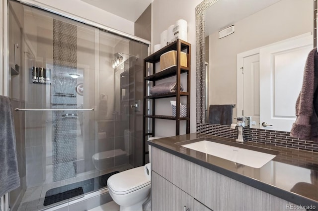 2898 W 22nd Ave, Denver, CO 80211 - bathroom featuring vanity, toilet, a stall shower, and backsplash