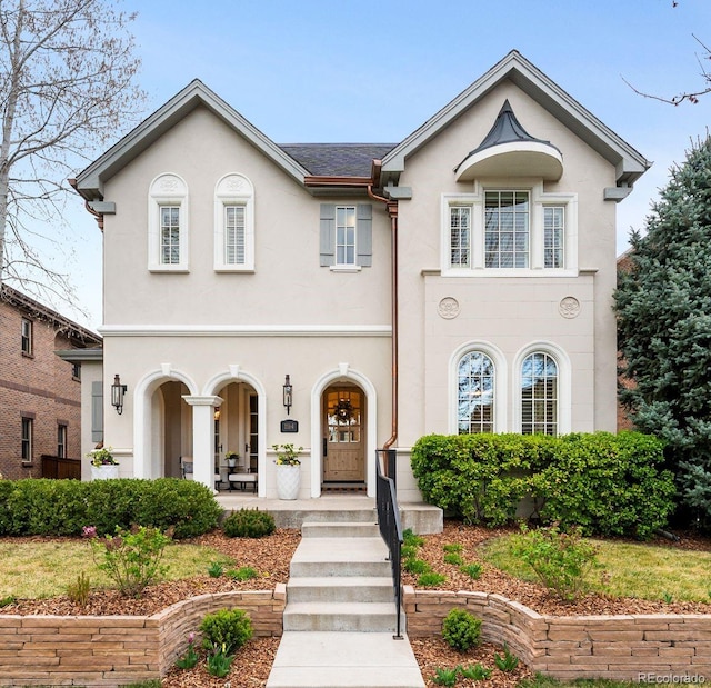 view of front of property with covered porch and stucco siding