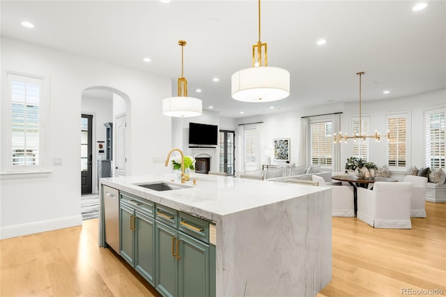 1164 S High St, Denver, CO 80210 - kitchen with green cabinetry, open floor plan, arched walkways, light wood finished floors, and recessed lighting