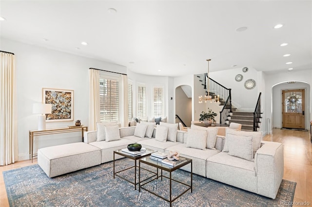 1164 S High St, Denver, CO 80210 - living room with arched walkways, stairway, wood finished floors, and recessed lighting