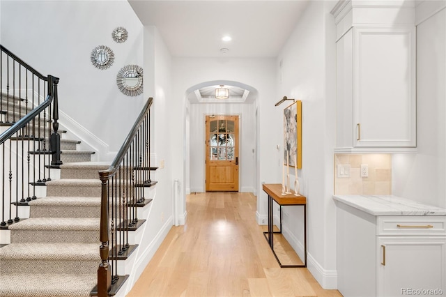1164 S High St, Denver, CO 80210 - entrance foyer with arched walkways, light wood-style floors, stairs, and recessed lighting