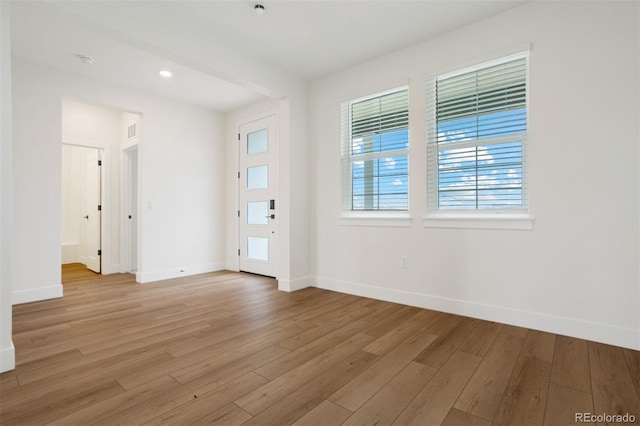 interior space featuring recessed lighting, baseboards, and light wood finished floors