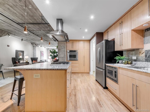 1449 Wynkoop St Unit 305, Denver, CO 80202 - kitchen with light brown cabinetry, stainless steel appliances, light stone countertops, a center island, and recessed lighting