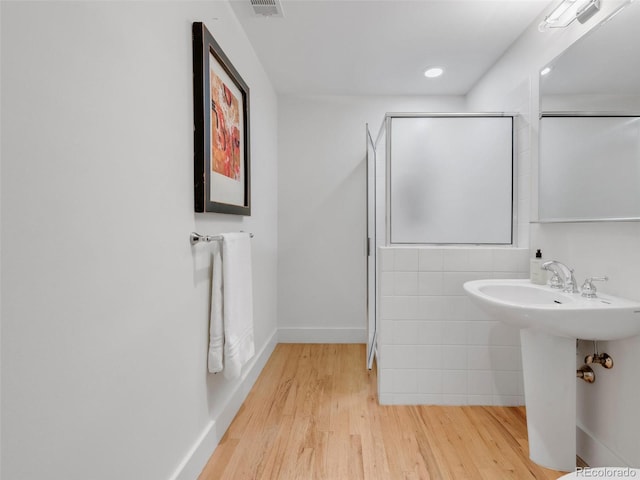 1449 Wynkoop St Unit 305, Denver, CO 80202 - full bathroom with wood finished floors, a sink, a shower, baseboards, and recessed lighting