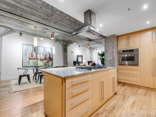 1449 Wynkoop St Unit 305, Denver, CO 80202 - kitchen with light brown cabinets, stainless steel appliances, island range hood, light stone countertops, and light wood-style flooring