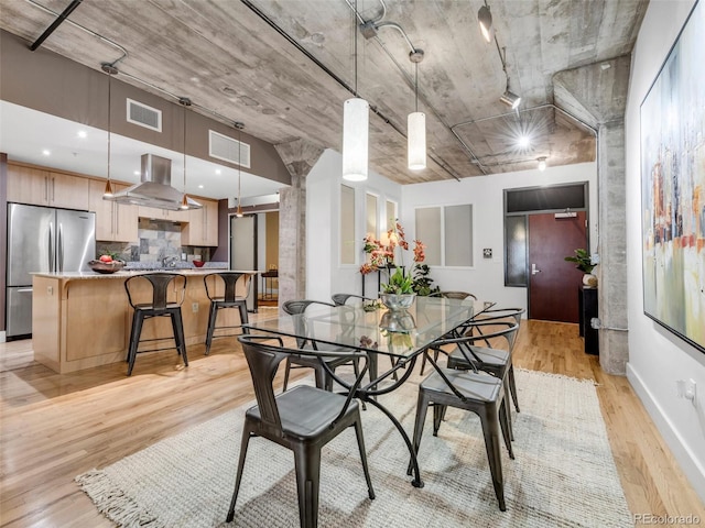 1449 Wynkoop St Unit 305, Denver, CO 80202 - dining area featuring light wood-style flooring and decorative columns
