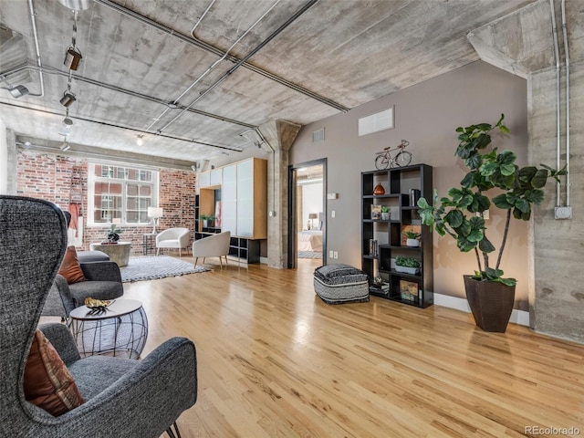 1449 Wynkoop St Unit 305, Denver, CO 80202 - living room with wood finished floors and brick wall
