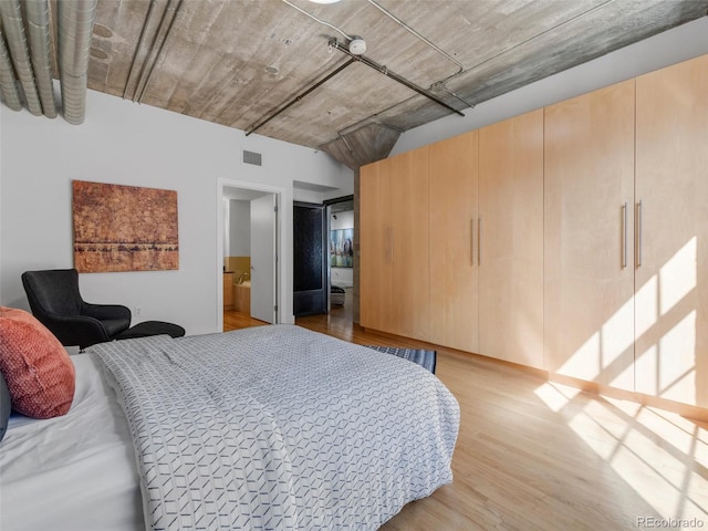1449 Wynkoop St Unit 305, Denver, CO 80202 - bedroom featuring light wood finished floors and ensuite bath